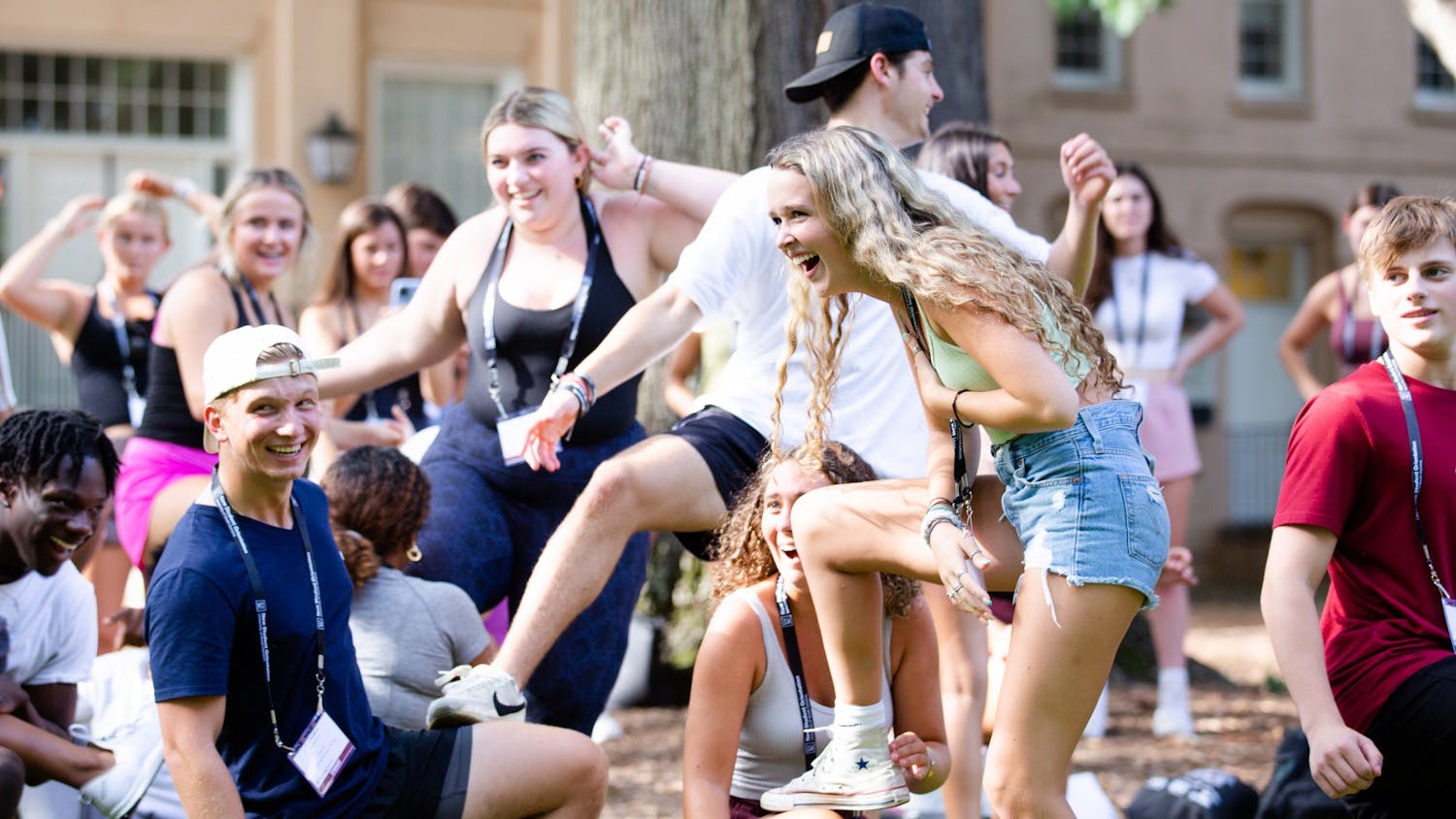 A first-year student laughs while she props her leg on another student's knee during a game on the Horseshoe on July 20, 2022. Students played games, listened to presentations and toured campus during orientation sessions held throughout the summer.