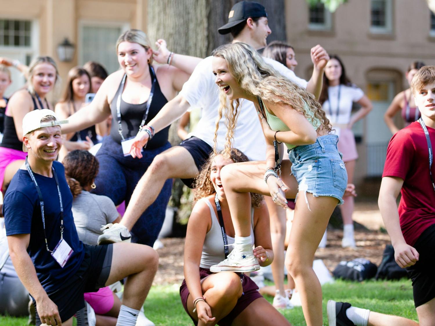 A first-year student laughs while she props her leg on another student's knee during a game on the Horseshoe on July 20, 2022. Students played games, listened to presentations and toured campus during orientation sessions held throughout the summer.