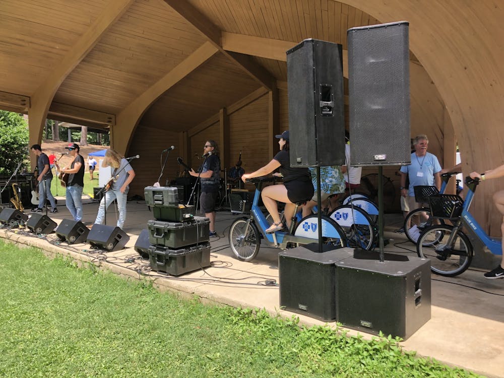 <p>Volunteers ride stationary bikes powering live music at SolFest RollFest on July 2, 2022. This is the first bike-powered music festival in Columbia.&nbsp;</p>