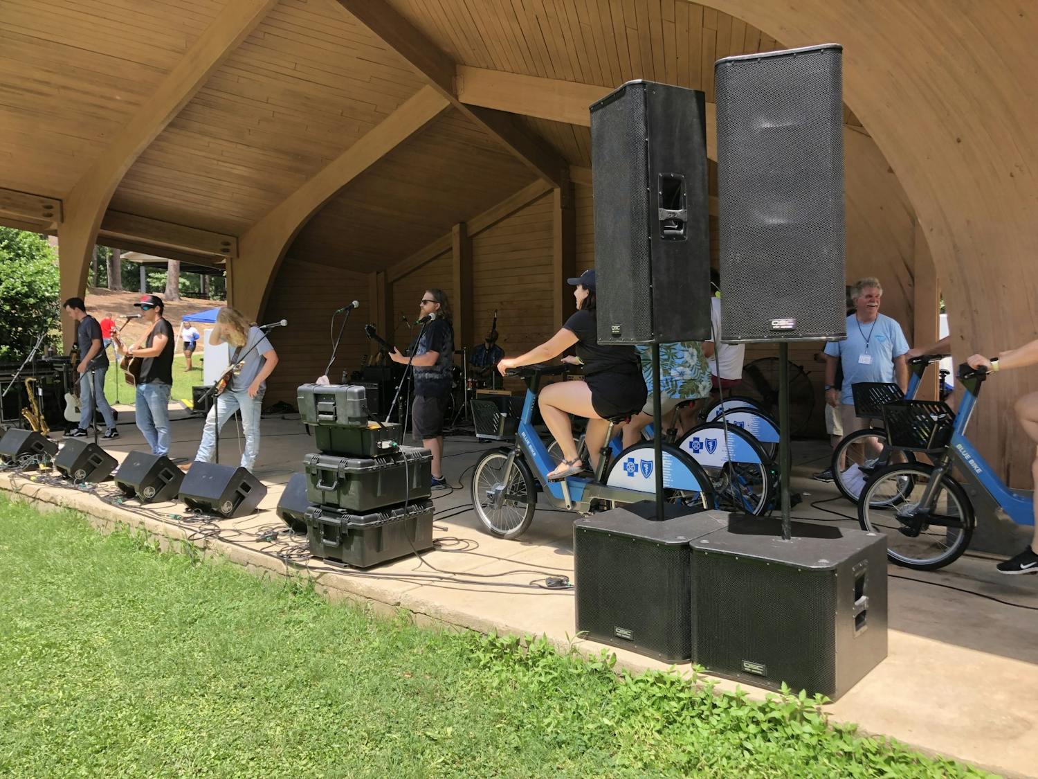 Volunteers ride stationary bikes powering live music at SolFest RollFest on July 2, 2022. This is the first bike-powered music festival in Columbia.&nbsp;