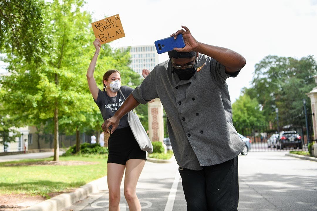 A Spice employee danced to the music that was playing before going back into Russell House. The students who were there cheered him on and danced with him.