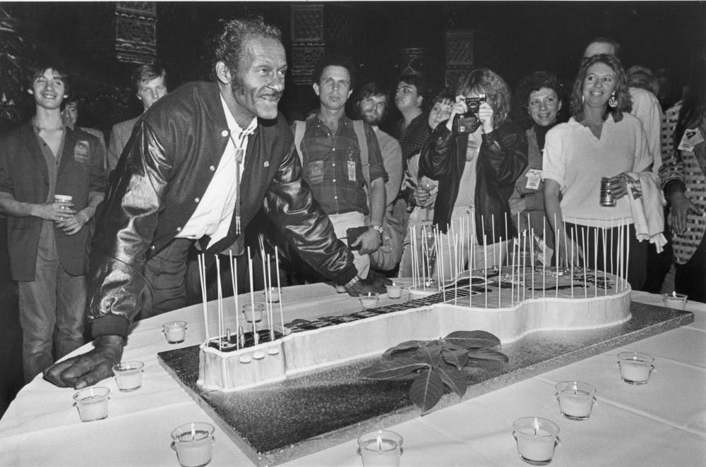 Chuck Berry poses next to a guitar-shaped birthday cake after his performance at the St. Louis Fox Theatre in Missouri on October 17, 1986. Berry died at 90 on Saturday, March 18, 2017. (Al Seib/Los Angeles Times/TNS)