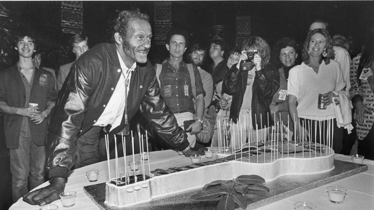Chuck Berry poses next to a guitar-shaped birthday cake after his performance at the St. Louis Fox Theatre in Missouri on October 17, 1986. Berry died at 90 on Saturday, March 18, 2017. (Al Seib/Los Angeles Times/TNS)