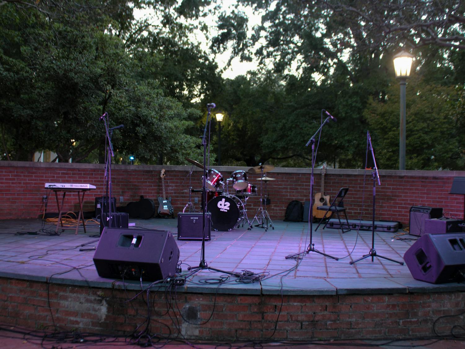 Microphones and sound equipment sit on an empty stage minutes before the Battle of the Bands concert event on Oct. 5, 2022. The competition brought a cappella, folk, rap and rock to the Russell House Patio in a variety of performances.