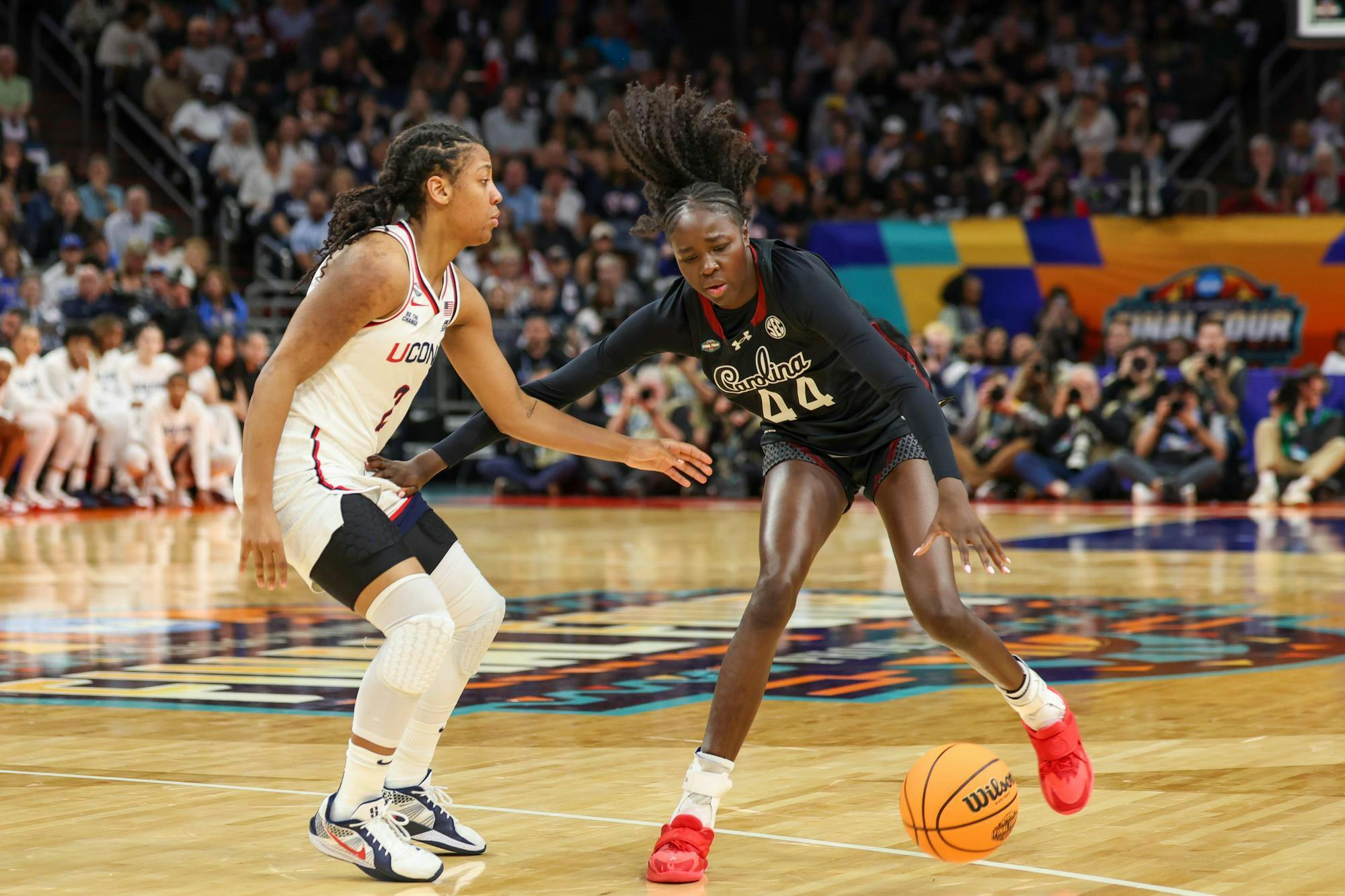 Freshman guard Agot Makeer dribbles the ball while guarded by a UConn defender during the semifinal game on April 3, 2026. Makeer made four rebounds and scored two 3-pointers.