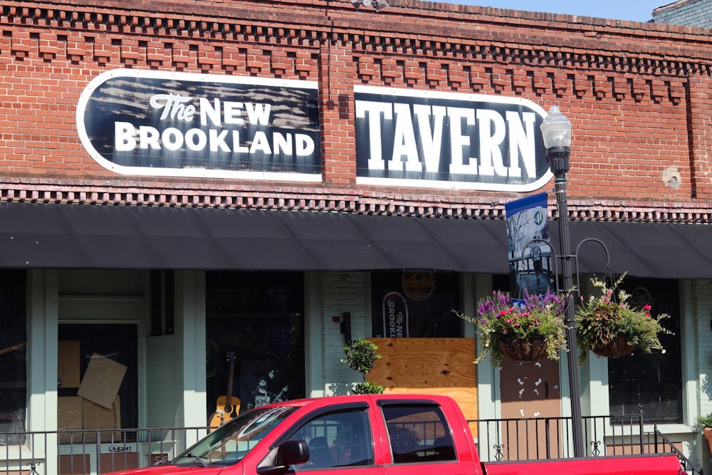 <p>A picture of a sign that says 'The New Brookland Tavern' on July 25, 2022. The sign hangs above the entrance of the smallest and one of the oldest concert venues in Columbia.&nbsp;</p>