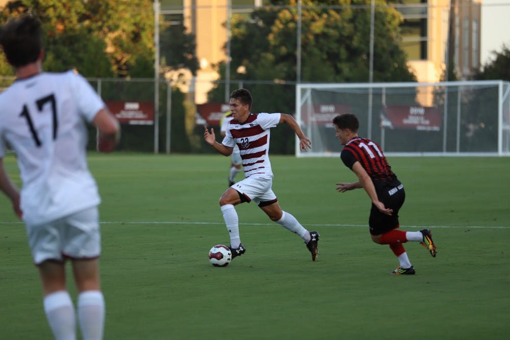 <p>Sophomore Elijah Bebout takes the ball down the field in the Gamecocks' match against Gardner-Webb on Tuesday evening.</p>