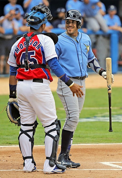 Cuban-Born Tampa Bay Rays Outfielder Dayron Varona is greeted by Cuban catcher Frank Camilo Morejon Reyes during game at the Estadio Latinoamericano between the Tampa Bay Rays and the Cuban National team on March 22, 2016 in Havana, Cuba. (Al Diaz/Miami Herald/TNS) 