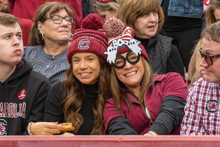 Two fans smile toward the camera during the matchup between South Carolina and Missouri on Oct. 29, 2022. The game fell on the weekend of Halloween, prompting many students and fans to dress up for the event.