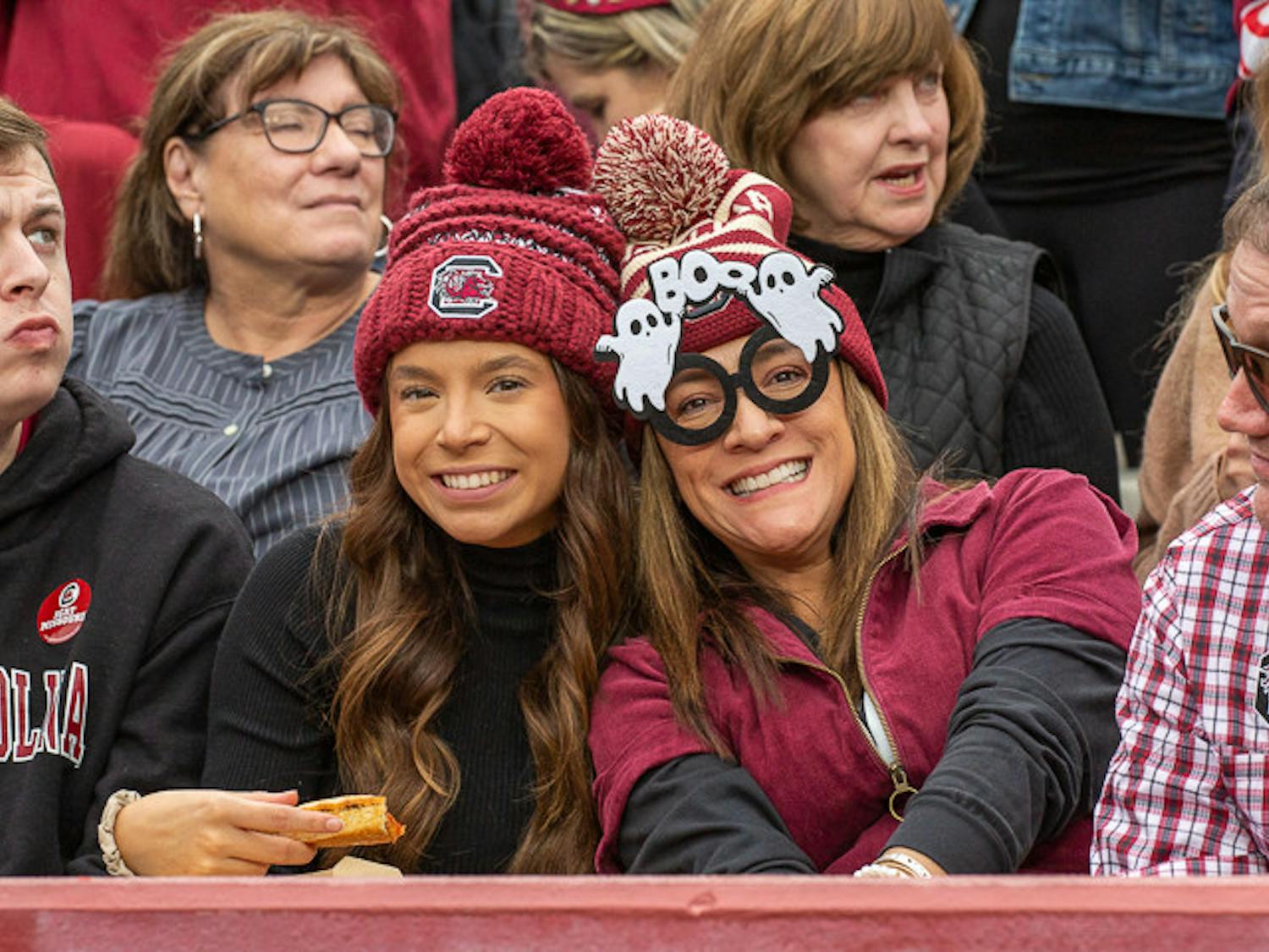 Two fans smile toward the camera during the matchup between South Carolina and Missouri on Oct. 29, 2022. The game fell on the weekend of Halloween, prompting many students and fans to dress up for the event.