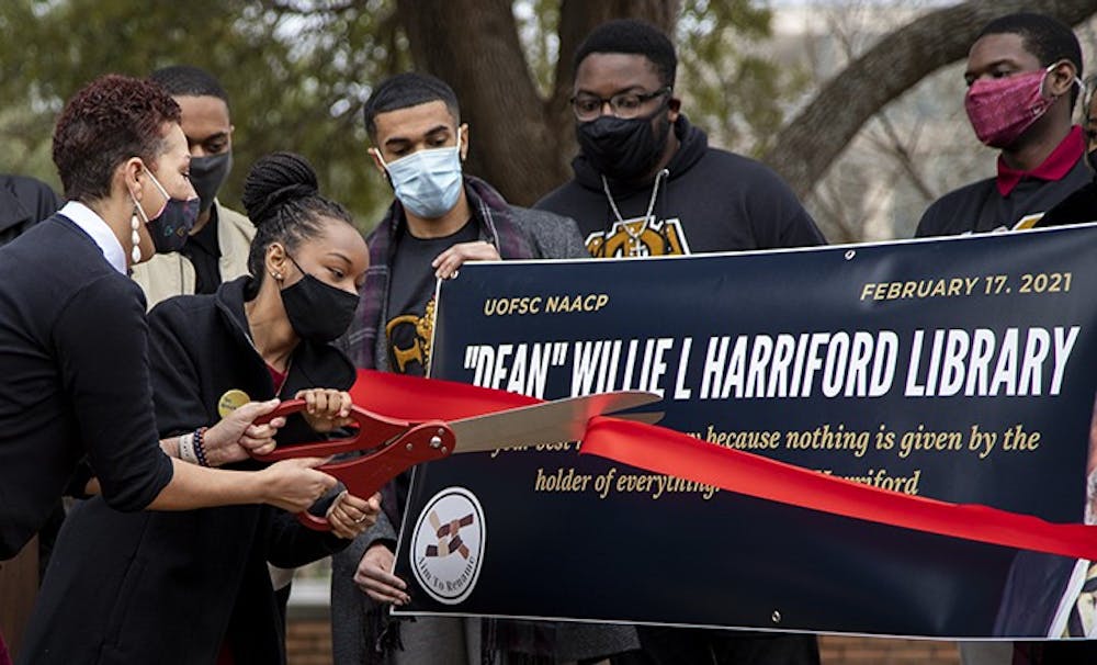 <p>NAACP chapter President Caley Bright cuts the ribbon during the NAACP press conference.&nbsp;</p>