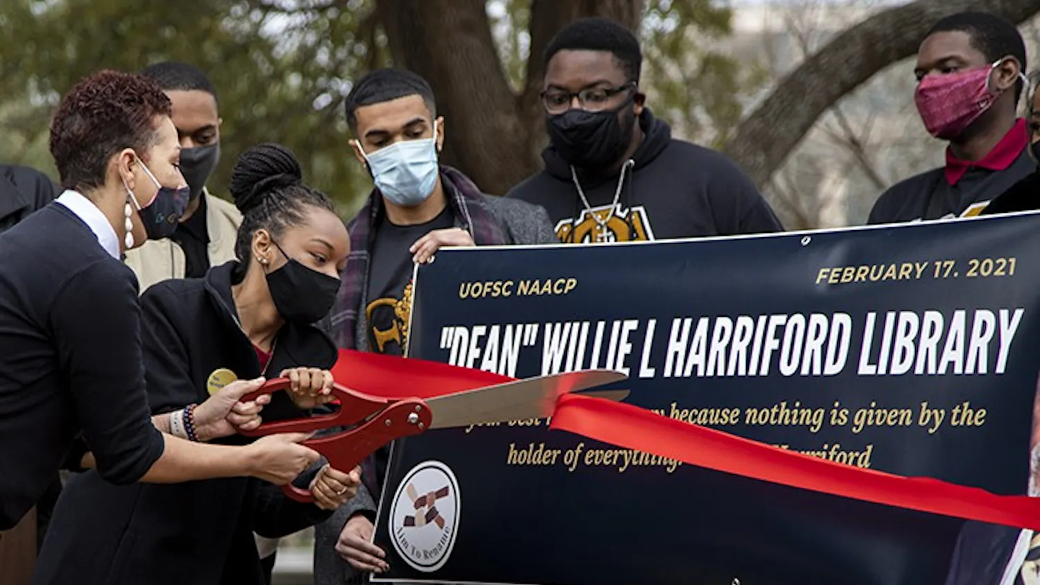 NAACP chapter President Caley Bright cuts the ribbon during the NAACP press conference. 