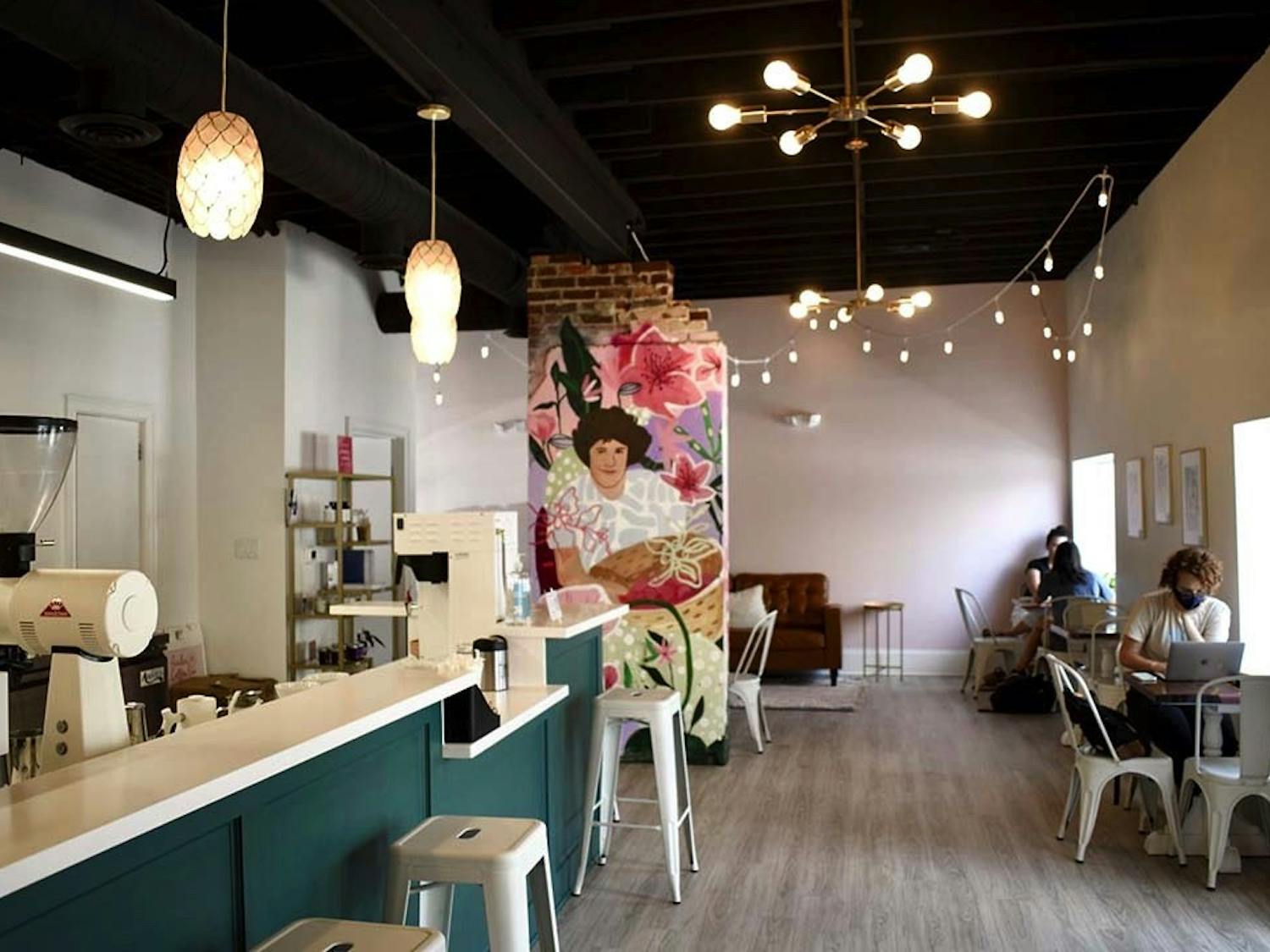 The interior of Azalea Coffee Bar, a chic new woman-owned establishment on Devine Street. The mural is of owner Brittany Koester's mother, and contributes to the shop's goal of uplifting women and reducing disparities in the industry. 