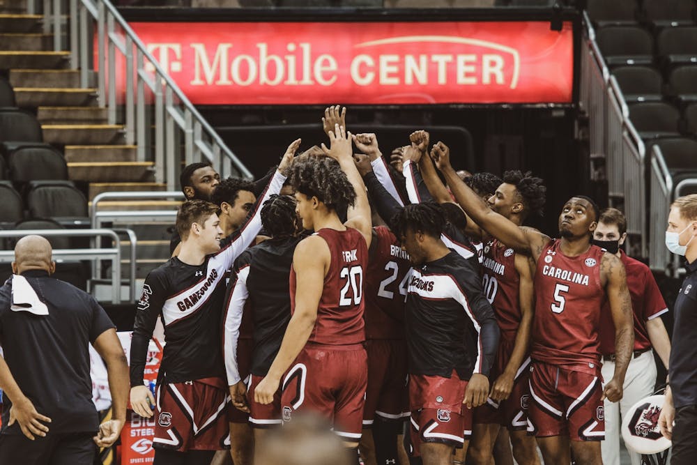 The South Carolina men's basketball team gathers during a timeout in a November game against Liberty. The team is now facing their third COVID-19-related pause of activities this season.