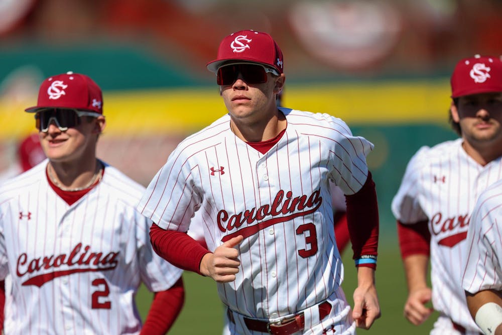<p>FILE — Junior infielder Patrick Evans runs back to the dugout with two teamates before the game against Northern Kentucky on Feb. 13, 2026. The Gamecocks defeated the Norse 2-1 in a weekend series of games.</p>