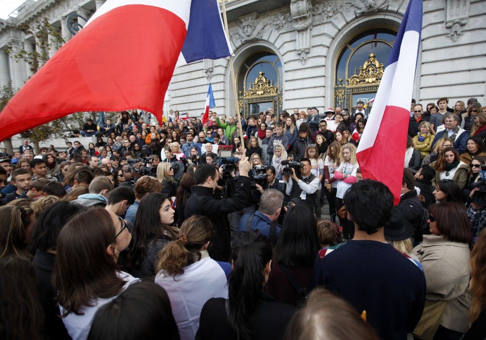 Hundreds of people gather on the steps of San Francisco City Hall for a vigil honoring victims of the Paris terrorist attacks on Sunday, Nov. 15, 2015, in San Francisco. (Karl Mondon/Bay Area News Group/TNS)