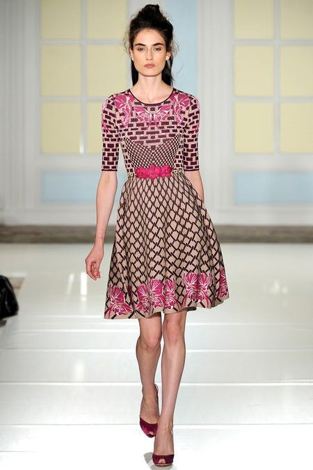 	This half-up, half-down look at Temperley London gets a messy makeover: topknot on top, frizz on bottom.