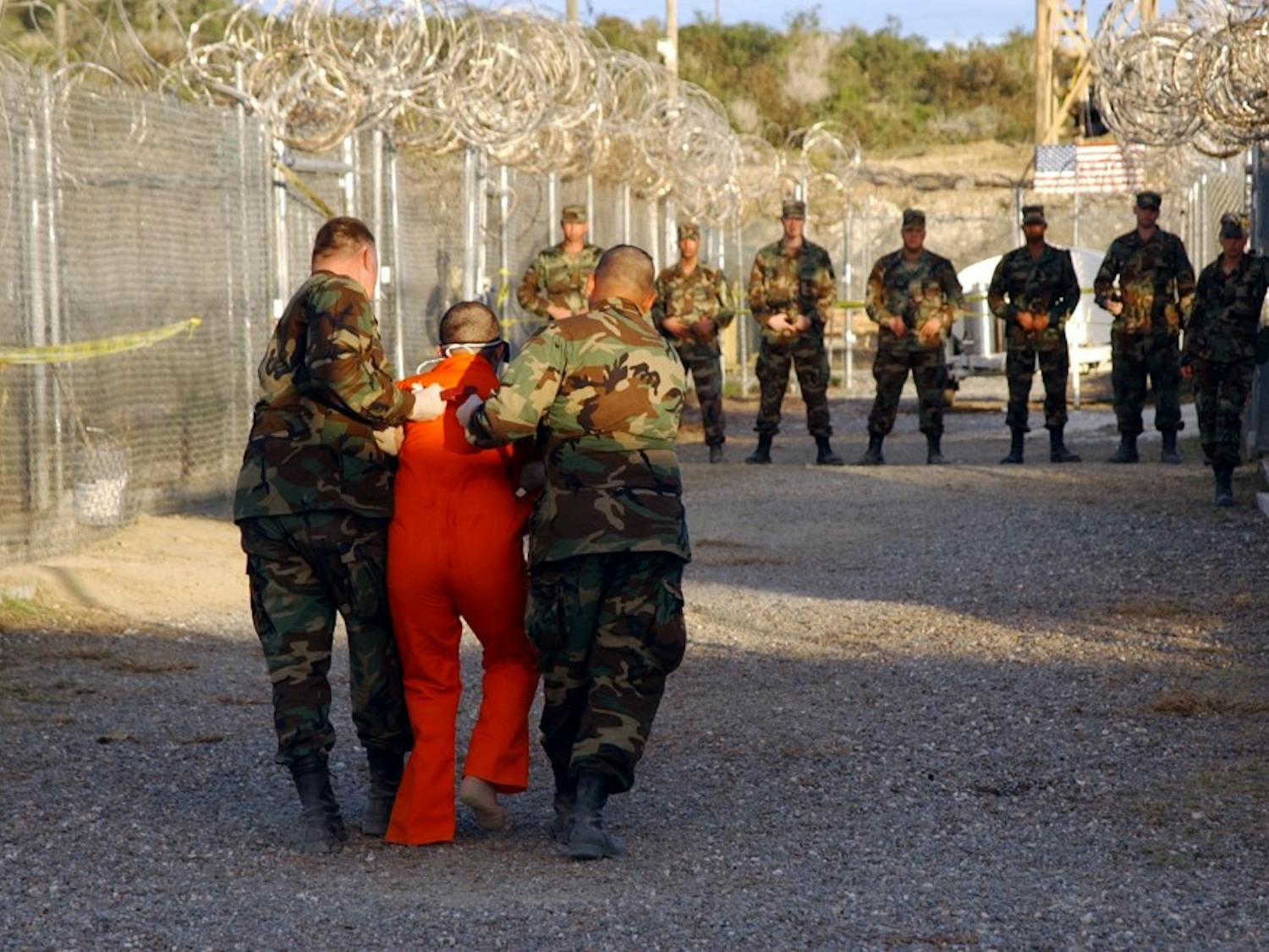 Taliban and al-Qaida detainees in orange jumpsuits sit in a holding area during in-processing to the temporary detention facility on Jan. 18, 2002, in Guantanamo Bay, Cuba. The Senate Select Committee on Intelligence released a report on the CIA's interrogation practices. The report said the CIA misled Americans and government policymakers about the effectiveness of the program that was secretly put into place after the 9/11 terror attacks. (Shane T. McCoy/ZUMA/TNS)