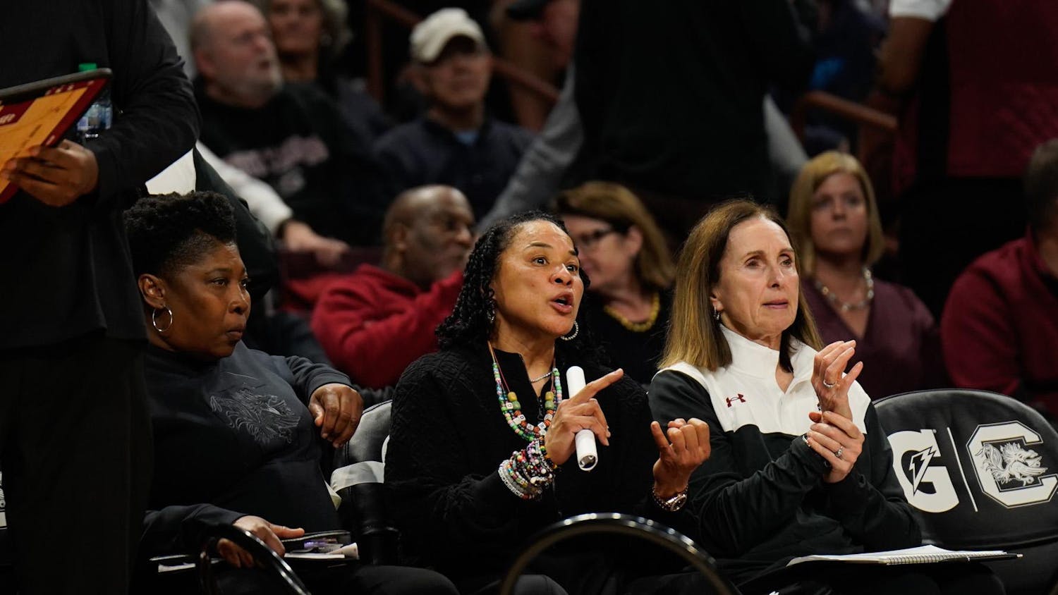 Head coach Dawn Staley and assistant coaches Mary Wooley and Jolette Law on the bench during the halftime shootaround before the start of the second half against Grand Canyon University at Colonial Life Arena on Nov. 3, 2025. The Gamecocks won this game 94-54.