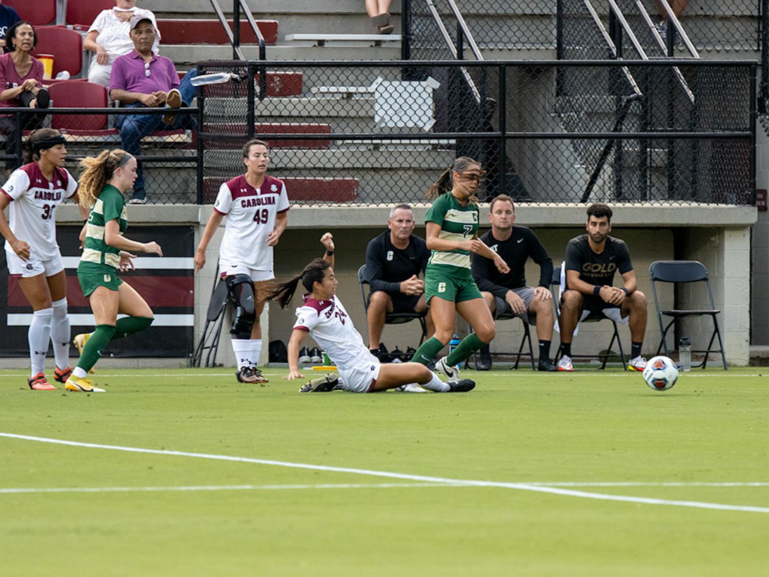 Graduate student midfielder Lauren Chang slides and removes control of the ball from Charlotte player. Chang assisted a goal made by junior forward Eveleen Hahn during the first half.