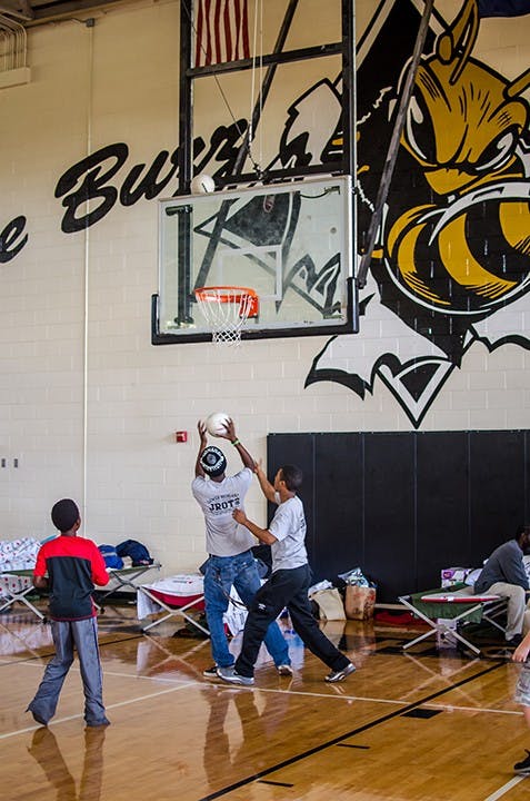 Children play basketball to pass the time at Lower Richland High School in Hopkins Red Cross shelter on October 6.