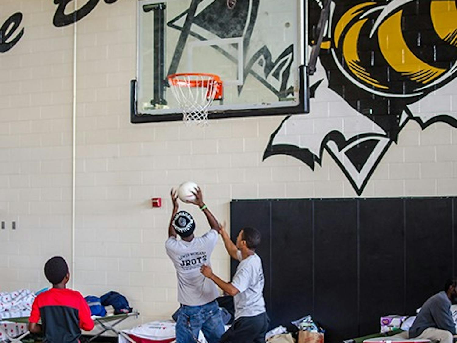 Children play basketball to pass the time at Lower Richland High School in Hopkins Red Cross shelter on October 6.