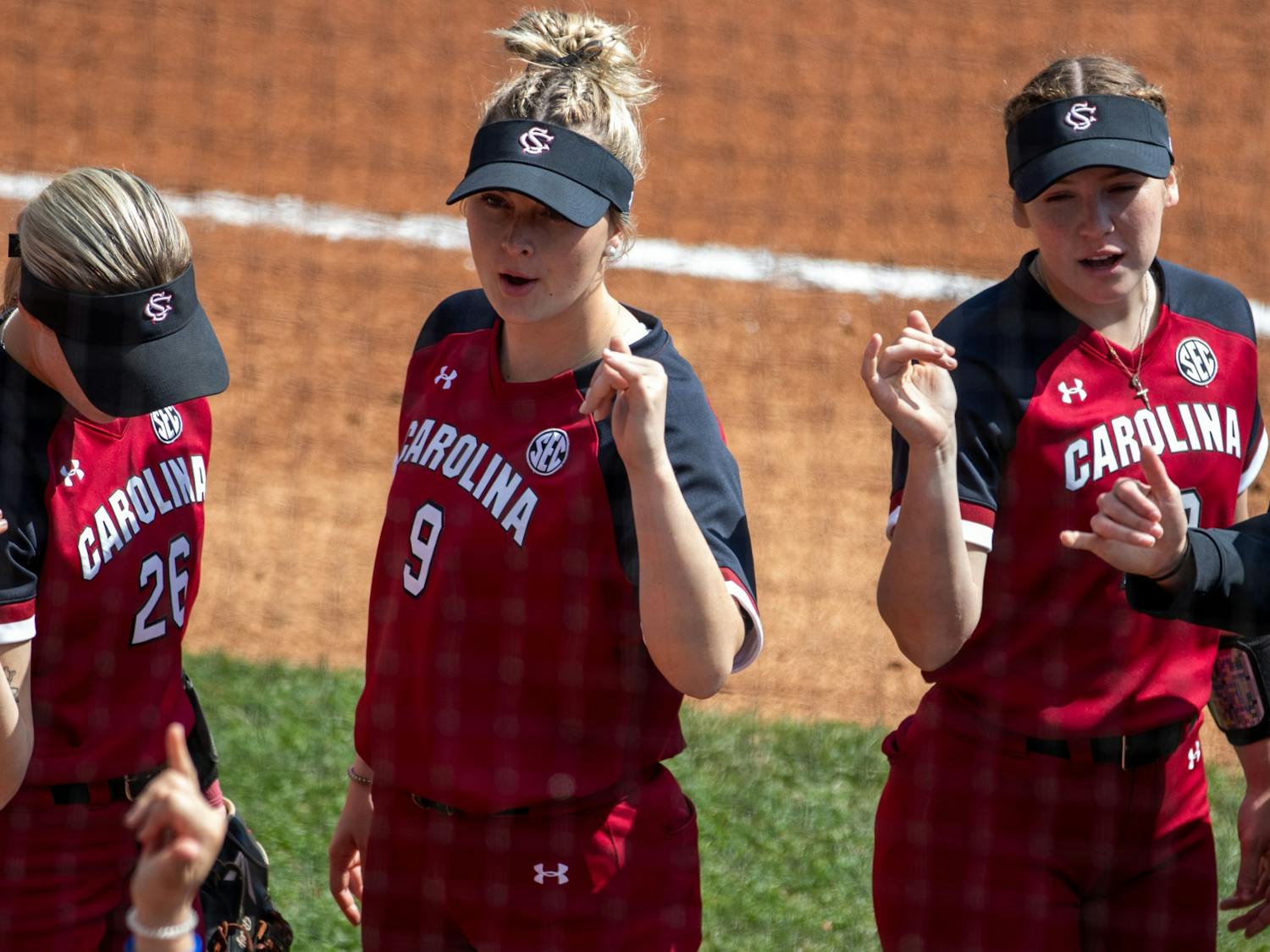 South Carolina softball players present spurs up hand gesture in preparation of their game against Virginia Tech on Saturday Feb. 26, 2022. The Carolina Gamecocks lost to the Virginia Tech Hokies 5-3.