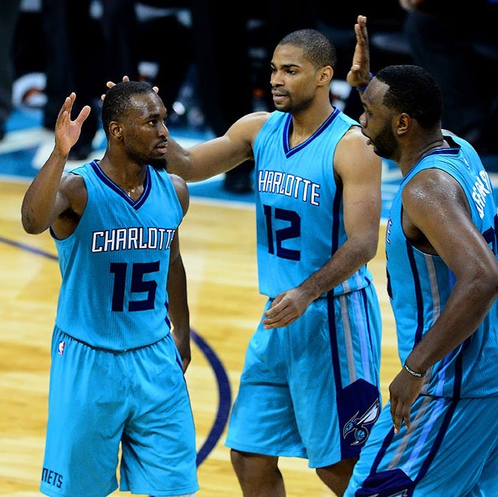 The Charlotte Hornets&apos; Kemba Walker (15) is congratulated by teammates Gary Neal (12) and Al Jefferson after hitting the game winning-basket against the Milwaukee Bucks on Wednesday, Oct. 29, 2014, at Time Warner Cable Arena in Charlotte, N.C. The Hornets won, 108-106, in overtime. (Jeff Siner/Charlotte Observer/MCT)