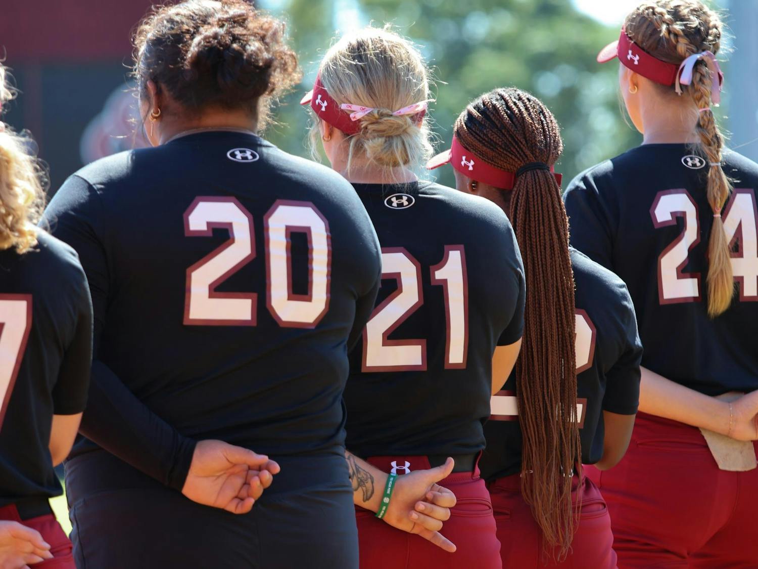 Redshirt junior infielder Natalie Heath makes a "spurs up" hand motion during the national anthem before South Carolina softball's exhibition game against USC Aiken on Oct. 12, 2024. The Gamecocks defeated the Pacers 14-1.