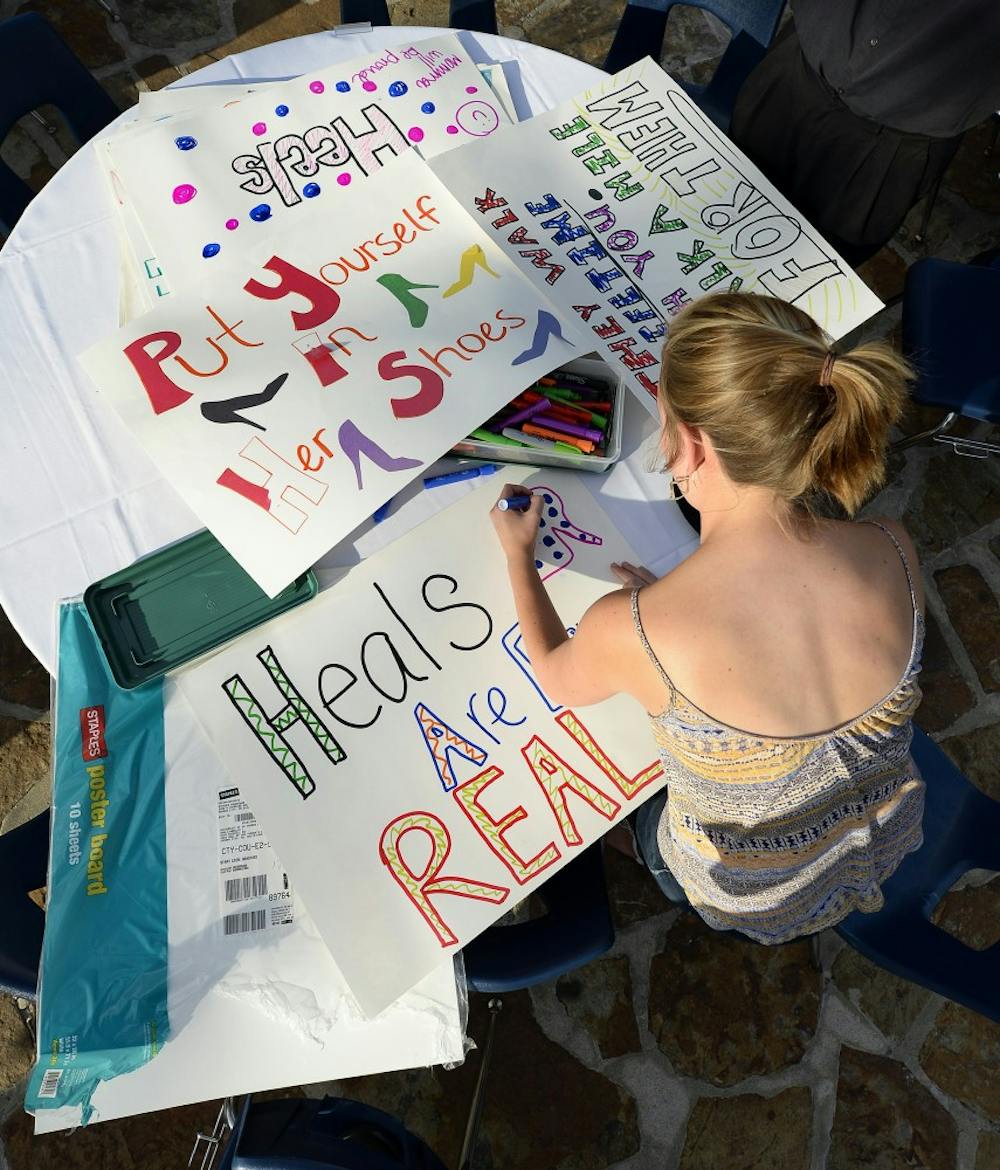 Sarah Gifford makes posters for the Walk a Mile in Her Shoes march against sexual assault and gender violence on Thursday, Sept. 17, 2015, at the University of Missouri Kansas City in Kansas City, Mo. (Keith Myers/Kansas City Star/TNS) 