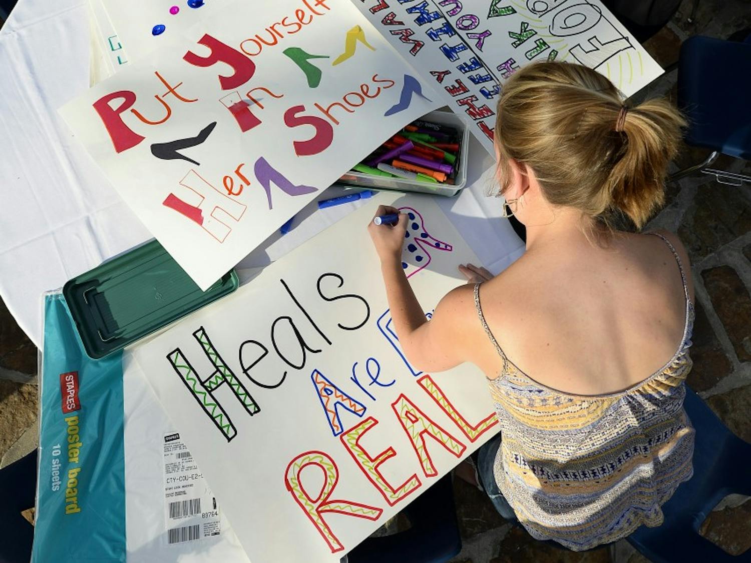 Sarah Gifford makes posters for the Walk a Mile in Her Shoes march against sexual assault and gender violence on Thursday, Sept. 17, 2015, at the University of Missouri Kansas City in Kansas City, Mo. (Keith Myers/Kansas City Star/TNS)
