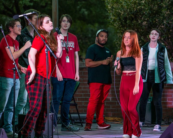 Third-year media arts student Alex Fossum (left) and third-year psychology student Erin McDonough (right) sing a duet during The Resonance's opening act on Oct. 5, 2022. The bands competed to be able to perform at the UofSC Homecoming Block Party on Oct. 28, 2022.