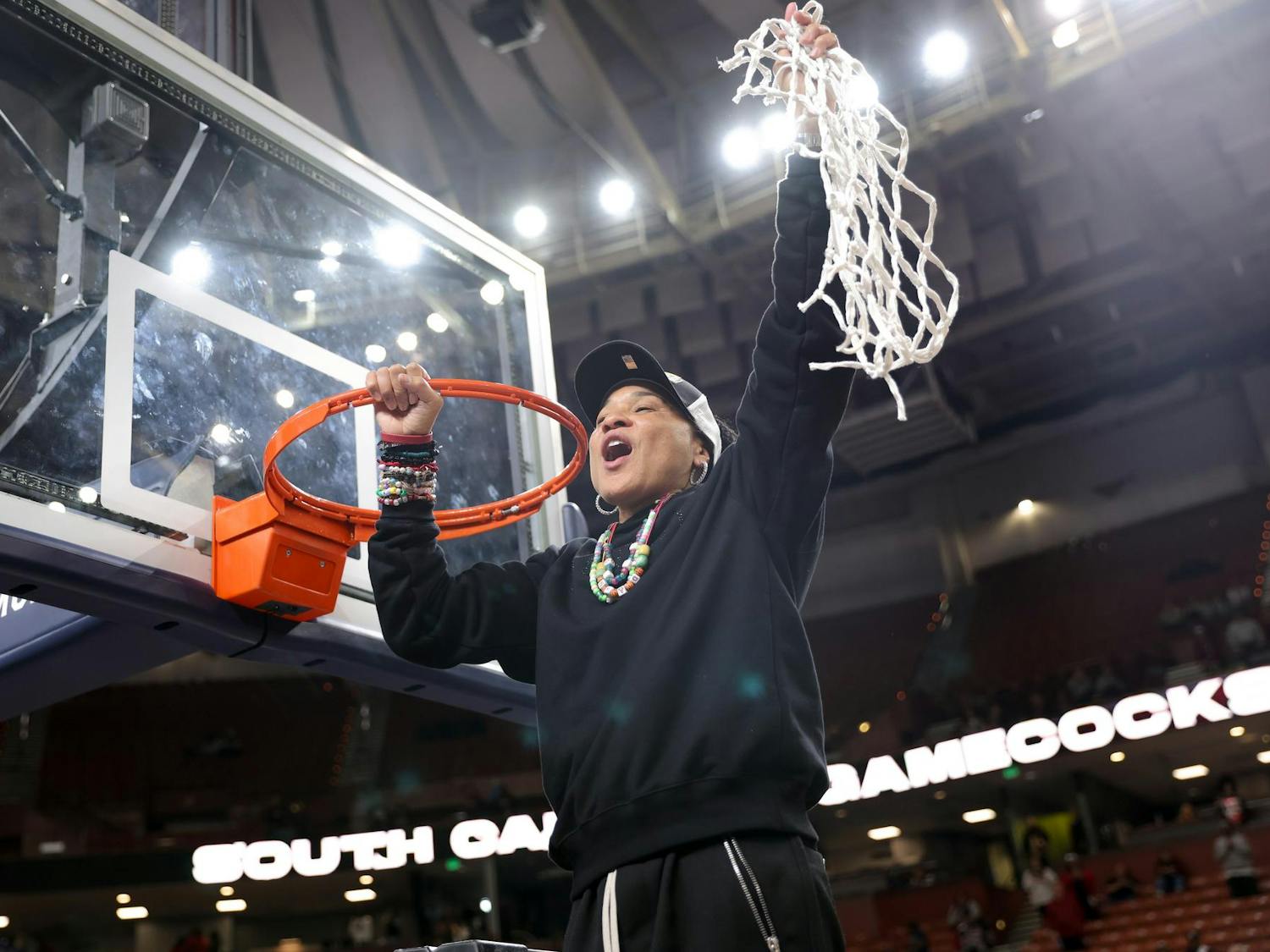 USC women's basketball head coach Dawn Staley holds up the cut down net after defeating Texas in the SEC Championship game on March 9, 2025. This game is the Gamecock's third straight SEC Championship win.
