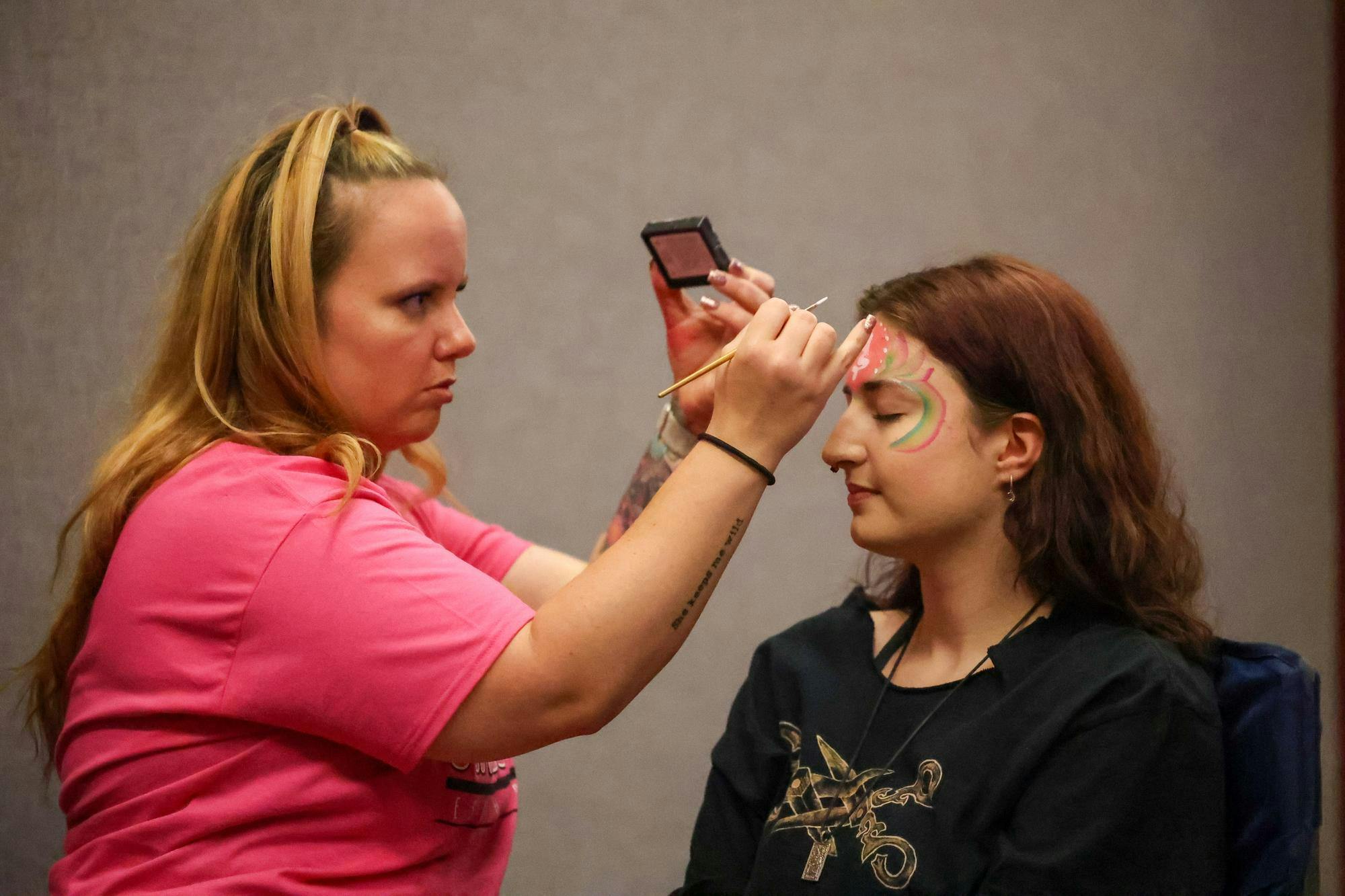 Second-year marine science student Ashley Zinsley gets her face painted before the drag performance begins in the Russell House Ballroom on April 14, 2026. IRIS, a social advocacy organization at USC, hosted Birdcage and provided pride flags, fans, balloons and snacks for anyone who attended.