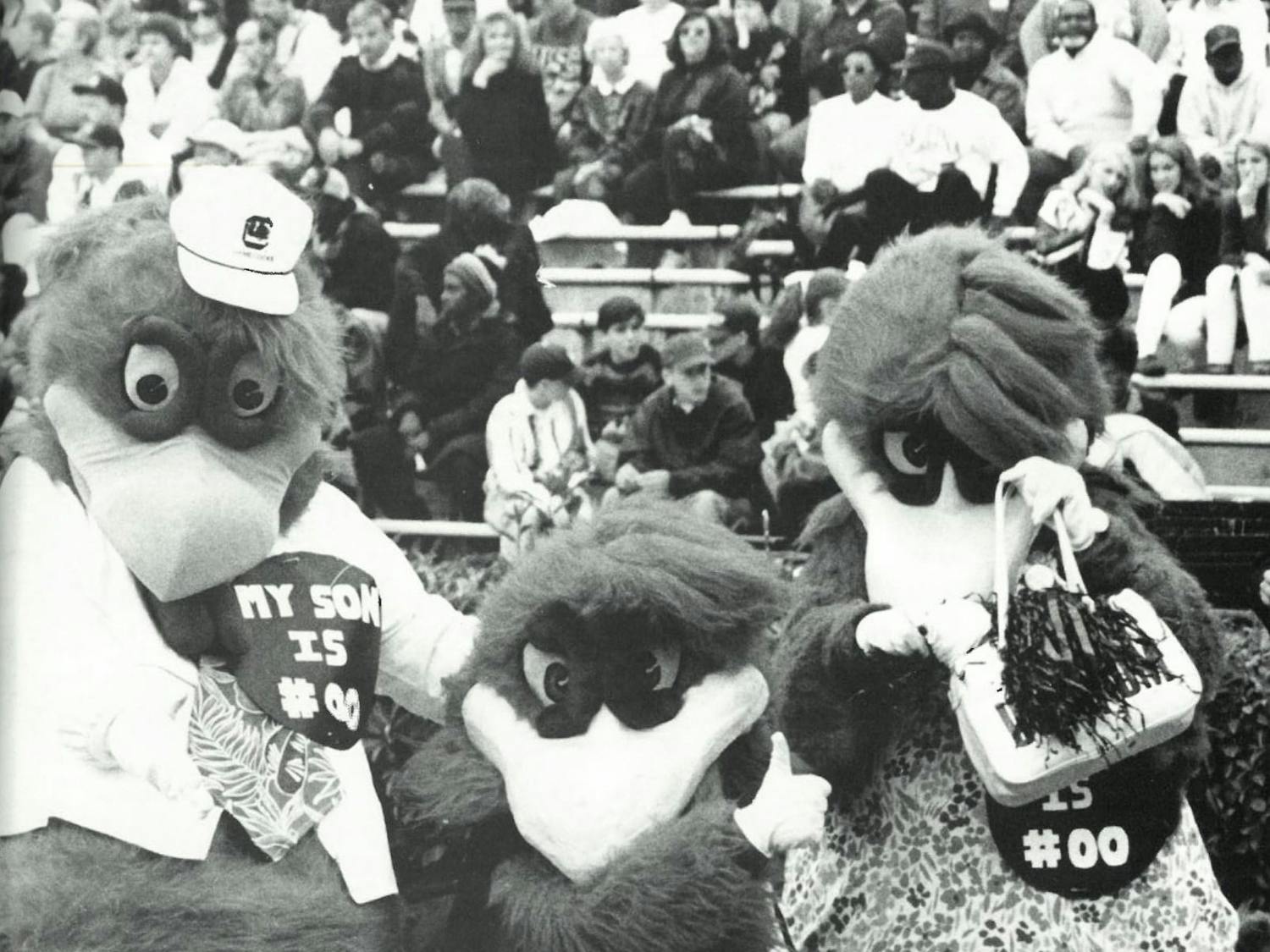 Cocky and his parents pose on the football field in 1994, displaying the Family Weekend tradition that is still seen today. The only difference is Cocky’s number, as today his jersey — and the supportive buttons his parents wear —&nbsp;read “MY SON IS #01."