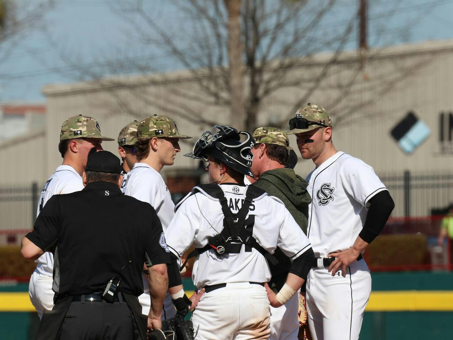 Gamecocks pitching coach talks with the team on the mound at Founders Park on Feb. 23. The Gamecocks went on to get out of the situation and continued its offensive dominance in the next half-innning.