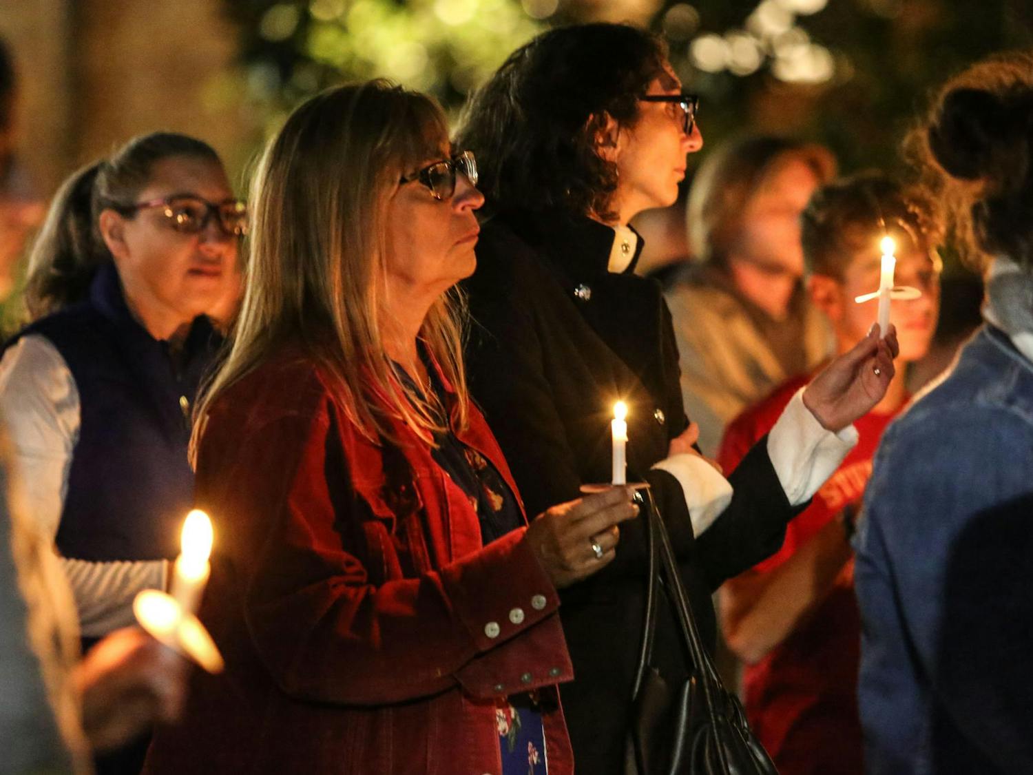 Attendees stand with lit candles in hand during a Jewish community vigil in the garden of the Anne Frank Center at the University of South Carolina on Oct. 17, 2023. The vigil was hosted by Gamecocks for Israel, Hillel at UofSC, Alpha Epsilon Pi, Chabad on Campus and the University of South Carolina.