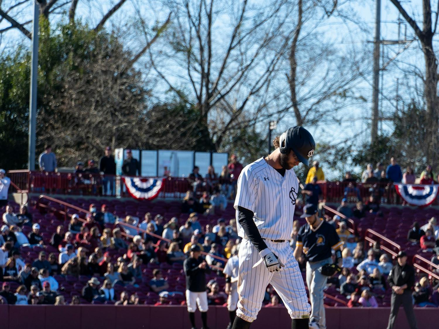 USC Senior Brandt Belk walks across the field at Founders Park on Feb. 19, 2022. Carolina lost their second game of their series with UNCG 4-5. 