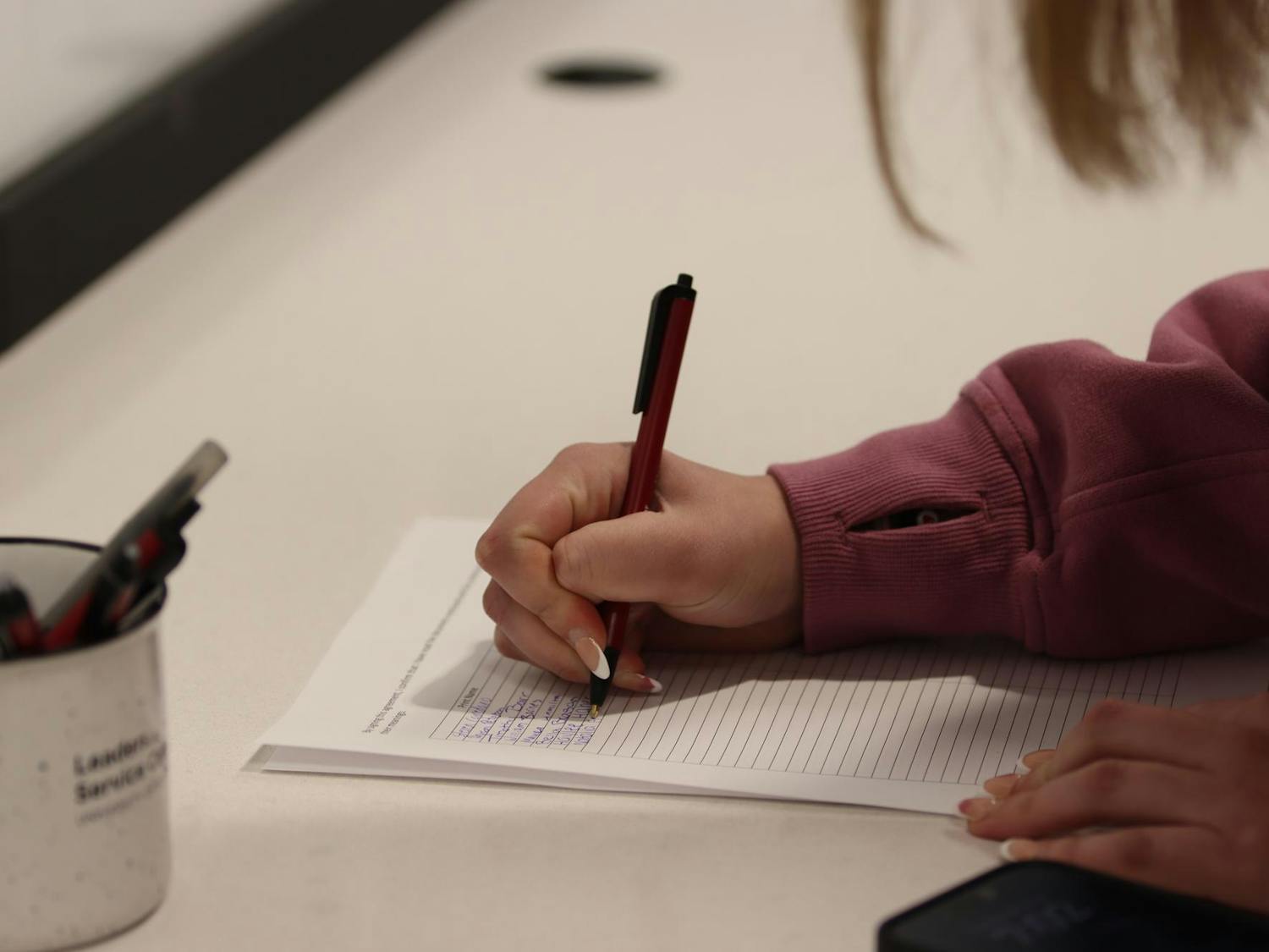 A student senate candidate signs in before an information session held in Russell House on Feb. 6, 2024. Candidates were allowed to begin their campaigns as early as the conclusion of the mandatory meeting.