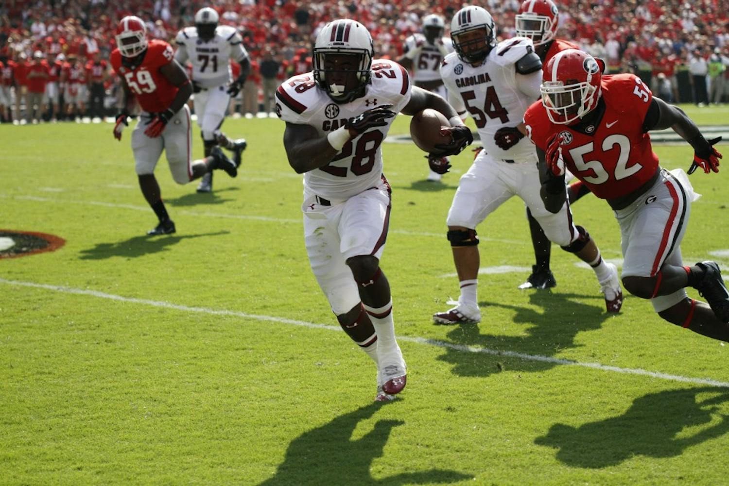 	South Carolina running back Mike Davis runs past the Georgia defense. He became the first player in Gamecock history to have two career 75-plus-yard runs.