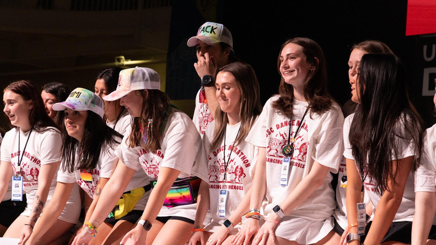 During the Dance Marathon main event, the atmosphere was joyful at the Strom Thurmond Wellness and Fitness Center on Saturday, Feb. 24, 2024. Students sit on the edge of the stage before the total funds raised for Prisma Health Children's Hospital are revealed.