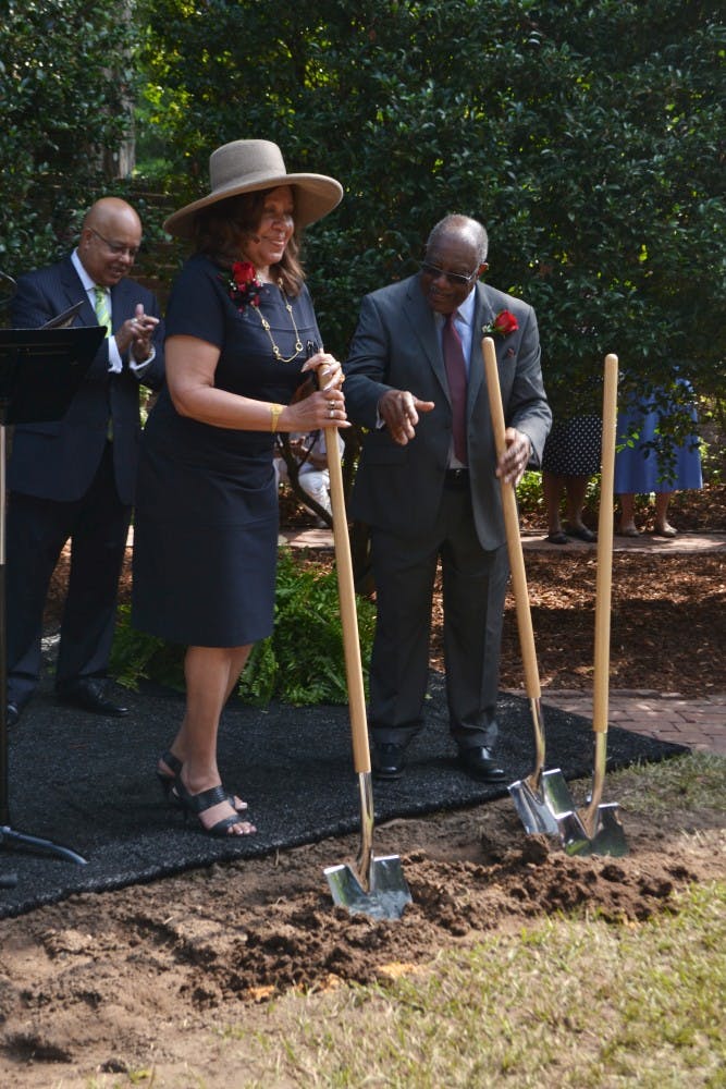 	Henrie Monteith Treadwell and James Solomon Jr. turn over the dirt at the site of the future desegregation reflection garden, leaving a shovel stationary in remembrance of Robert Anderson, who, with Treadwell and Solomon, desegregated the university in 1963.