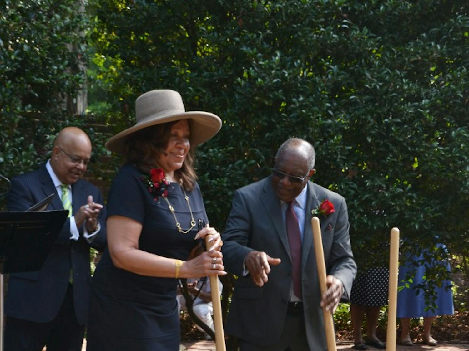 	Henrie Monteith Treadwell and James Solomon Jr. turn over the dirt at the site of the future desegregation reflection garden, leaving a shovel stationary in remembrance of Robert Anderson, who, with Treadwell and Solomon, desegregated the university in 1963.