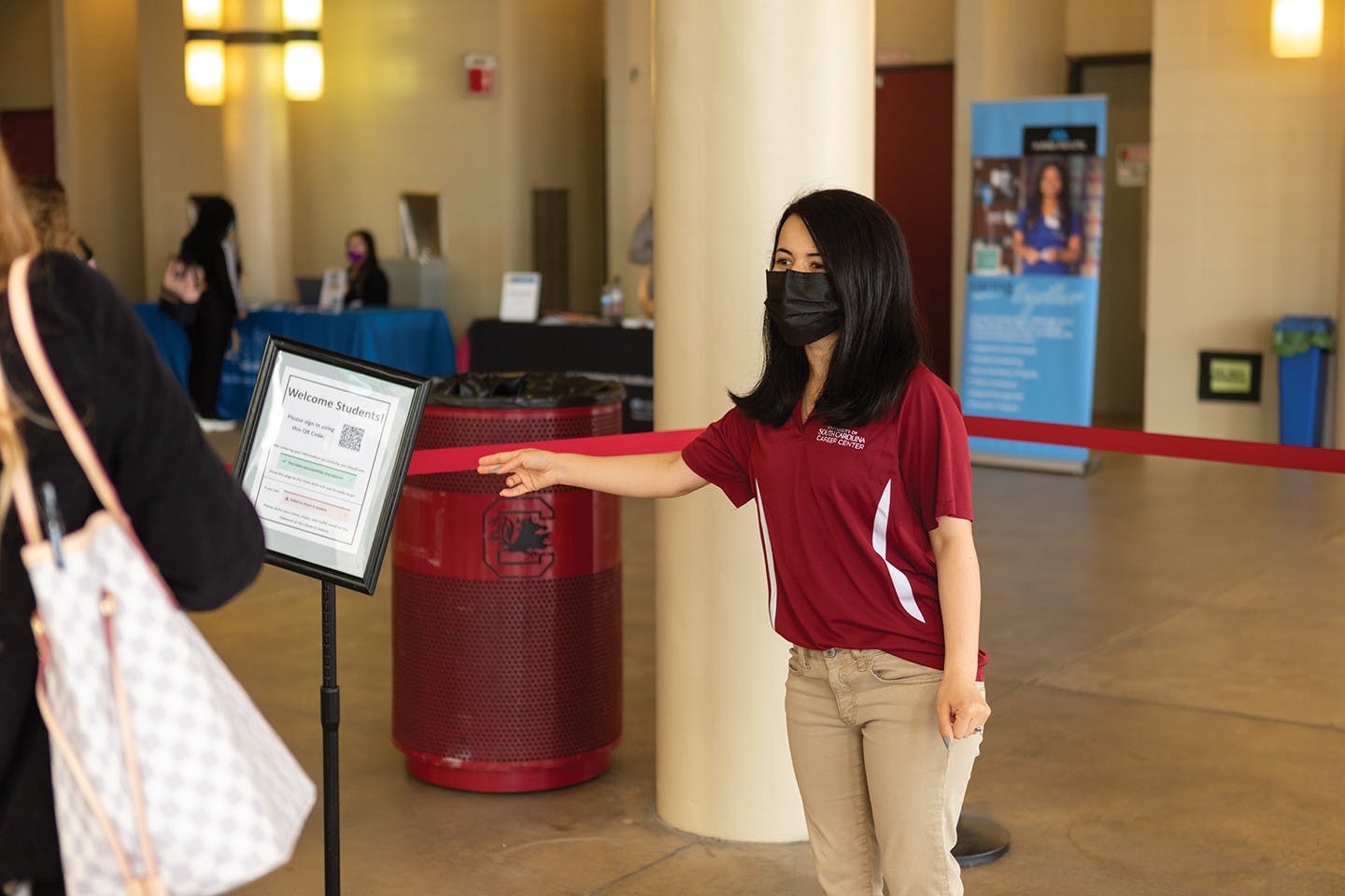 Ph.D. student Zo Sediqi directs students during the Health and Wellness job fair hosted by the USC Career Center on Feb. 2, 2022.