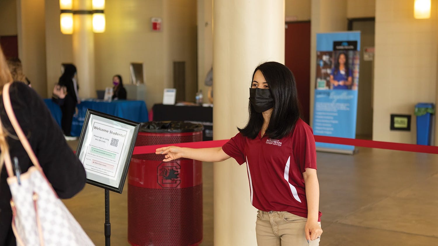Ph.D. student Zo Sediqi directs students during the Health and Wellness job fair hosted by the USC Career Center on Feb. 2, 2022.