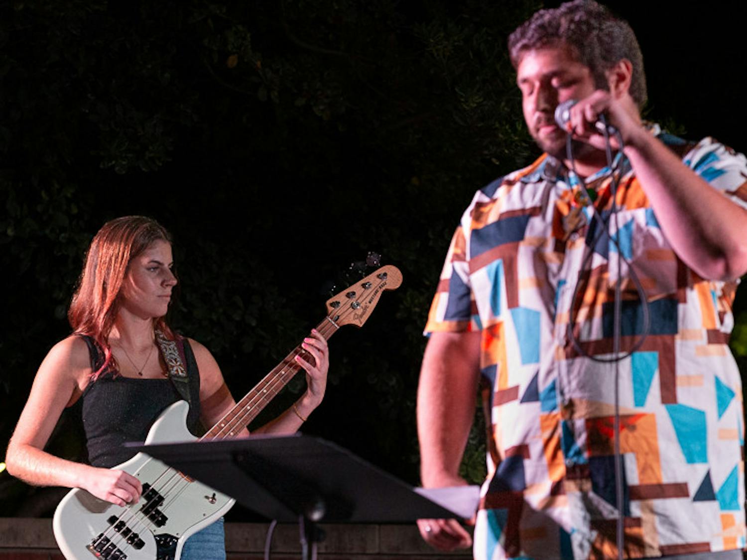 The House Band's bassist, fourth-year mathematics student Madison Adams (left), and lead singer, third-year international business and finance student Tyler Bomse (on right) perform at the battle of the bands on Oct. 5, 2022. The House Band won the competition and will be performing at the UofSC Homecoming Block Party on Oct. 5, 2022.