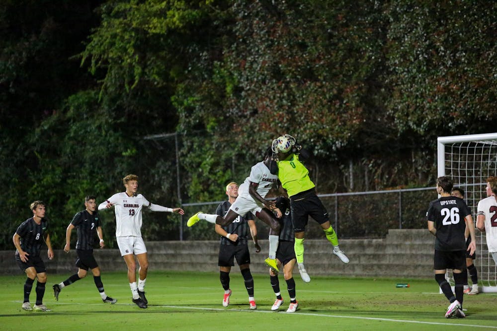 <p>The USC Upstate goalie defends the ball as sophomore defense Junior Juste attempts to head the ball into the goal. The Upstate Spartans dominated the South Carolina Gamecocks with a 4-0 win.</p>