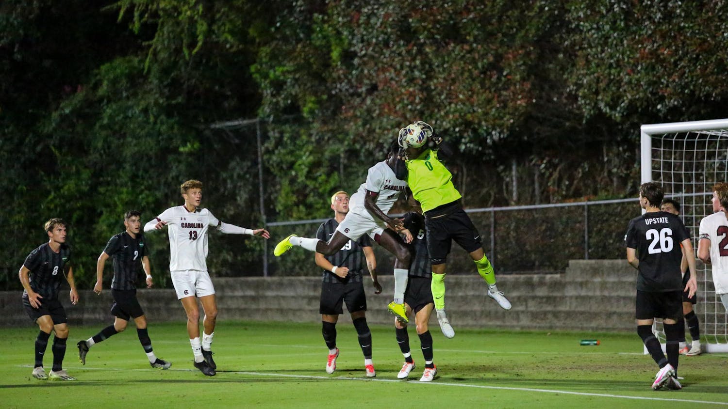 The USC Upstate goalie defends the ball as sophomore defense Junior Juste attempts to head the ball into the goal. The Upstate Spartans dominated the South Carolina Gamecocks with a 4-0 win.