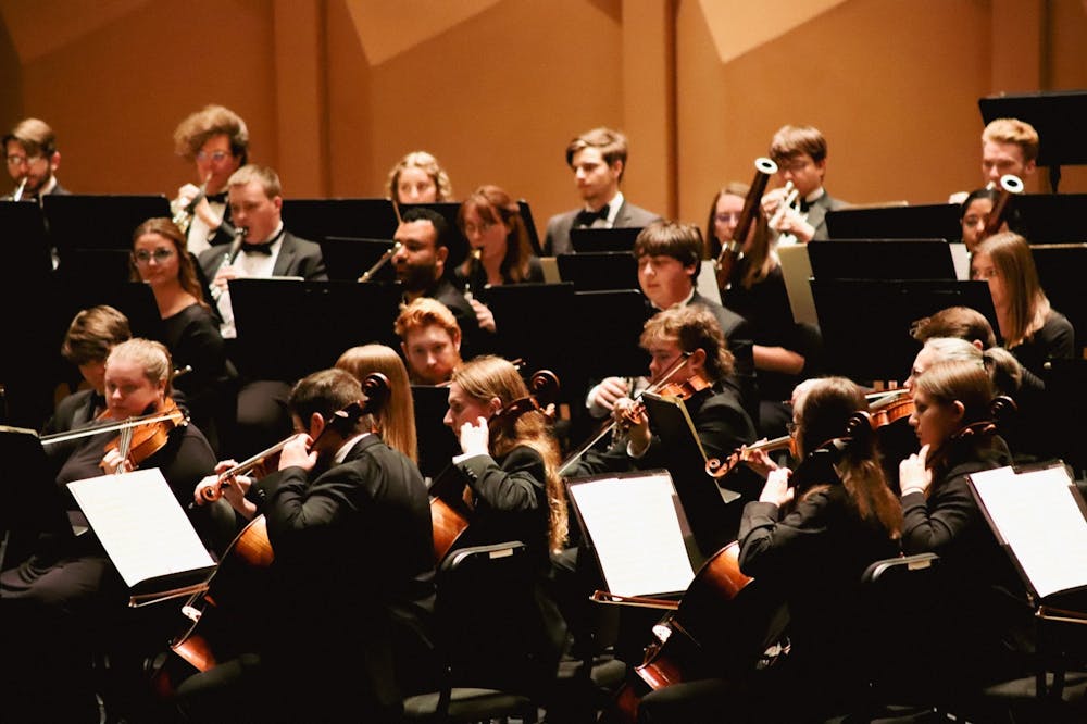 <p>The USC Symphony Orchestra performs its concert “Natasha Paremski Plays Rachmaninov” in the Koger Center for the Arts' Gonzales Hall on Nov. 29, 2022. The program included Johannes Brahms’ "Symphony No. 3" and Sergei Rachmaninov’s "Piano Concerto No. 2." This photo features both string players, primarily cellists and violists, and wind players.</p>