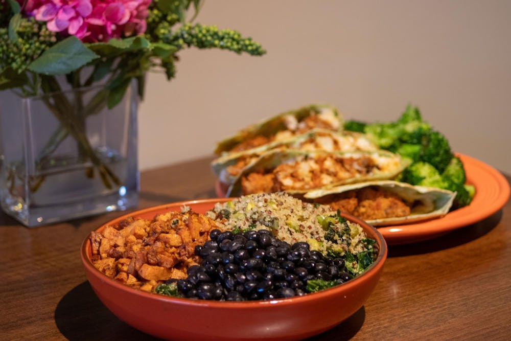 <p>A harmony bowl and a buffalo cauliflower quesadilla dish sit on a table inside the Good Life Cafe&nbsp;on Jan. 29, 2024. The dishes are only two of the many healthy, vegan and non-vegan menu options offered by the restaurant.</p>